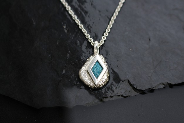 Sterling Silver and Harris Tweed - Approx 20mm with an 18inch chain. Rock texture and turquoise blue sea 