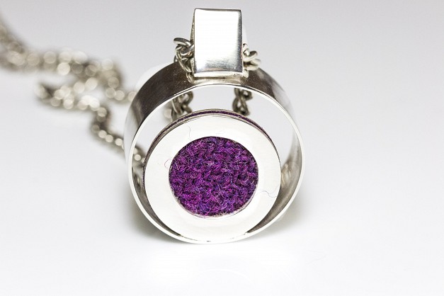 Sterling Silver necklace on a long (40inch)chain with circular frame and Purple/Pink Harris Tweed 